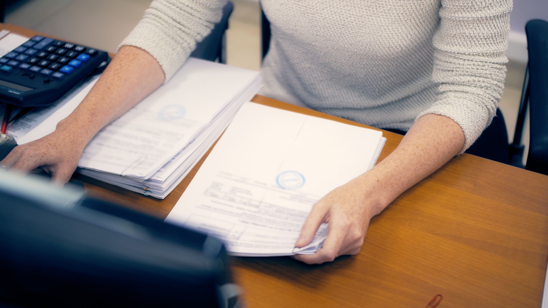 Woman in office working with documents. Quarterly report